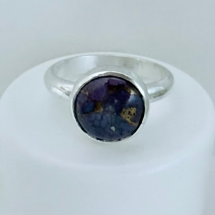 A handmade ring set with a purple sugilite stone
